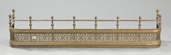 Large Edwardian Brass Fire Fender,: Large Edwardian Brass Fire Fender, late 19th century, with a turned brass-spindled gallery across the top, the curved frame with pierce-cut floral ornamentation, h. 11-1/2", w. 39-1/2", d. 12".