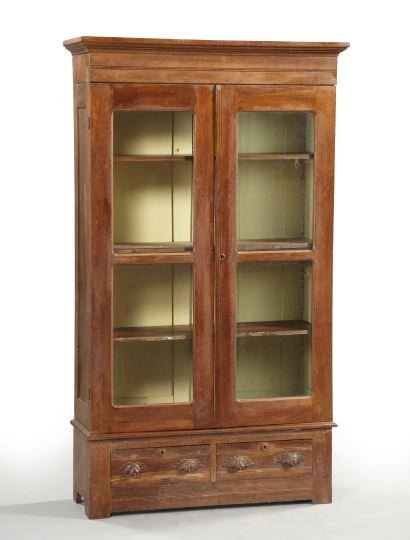 American Late Victorian Walnut Bookcase,: American Late Victorian Walnut Bookcase, late 19th century, the stepped molded cornice over a pair of bisected glazed doors, with a pair of drawers below, on bracket feet, h. 79-1/2", w. 45", d. 15-1/