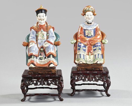 Chinese Polychromed and Porcelain Figures: Pair of Chinese Polychromed and Parcel-Gilt Porcelain Figures, depicting a Mandarin and Mandarine in traditional formal dress and seated in yoke-back chairs, each figure with a stenciled reign mark in