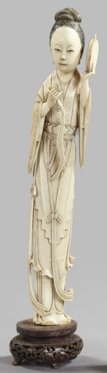 Kuang Hsu Elaborately Carved Tusk Ivory Figure: Kuang Hsu Elaborately Carved Tusk Ivory Figure of a Woman, first quarter 20th century, the figure modeled bearing a whisk and a tambourine, presented on a Chinese highly carved hardwood display stand 