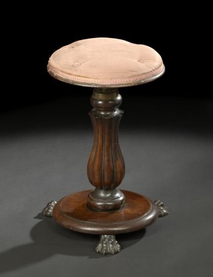 William IV Mahogany Piano Stool,: William IV Mahogany Piano Stool, second quarter 19th century, the padded circular seat of revolving adjustable height, raised on a reeded bulbous standard to a circular base on paw feet, h. 17-3/4", d