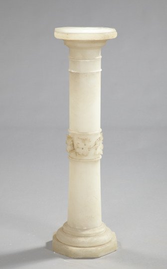 Italian Carved White Alabaster Pedestal,: Italian Carved White Alabaster Pedestal, first quarter 20th century, of hexagonal form in the Early Renaissance style, the mid-section of the cylindrical shaft carved with scrolling grapevines and gra