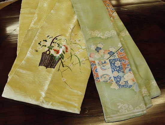 Two Japanese Taisho Embroidered Silk Damask Obi: Two Japanese Taisho Embroidered Silk Damask Obi, first quarter 20th century, one of patterned soft yellow ground and featuring polychrome-embroidered baskets of flowers, w. 6", l. 132", the other of s