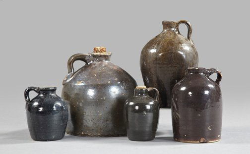 Albany Slip and Lustre Glazed Jugs: Collection of Five Albany Slip and Lustre Glazed Jugs, fourth quarter 19th century, four unsigned and one inscribed under the glaze "Dr. C.C. Massey's Little Brown Jug", the largest h. 7-1/2", dia. 7"