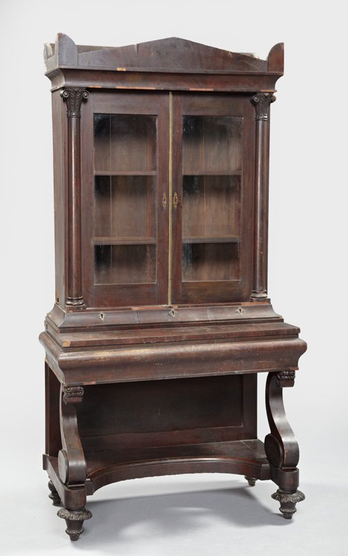 American Late Classical Mahogany Secretary: American Late Classical Mahogany Secretary Bookcase, second quarter 19th century, the top with a glazed bookcase above a row of three drawers, the base with a single long drawer and supported by scrol