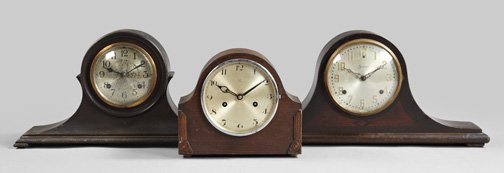 Three Round-Arched Wooden Mantel Clocks: Collection of Three Round-Arched Wooden Mantel Clocks, composed of a large Sessions "Dulciana" marquetry-stenciled mahogany example, signed on the silvered brass dial with an interior paper label; a G