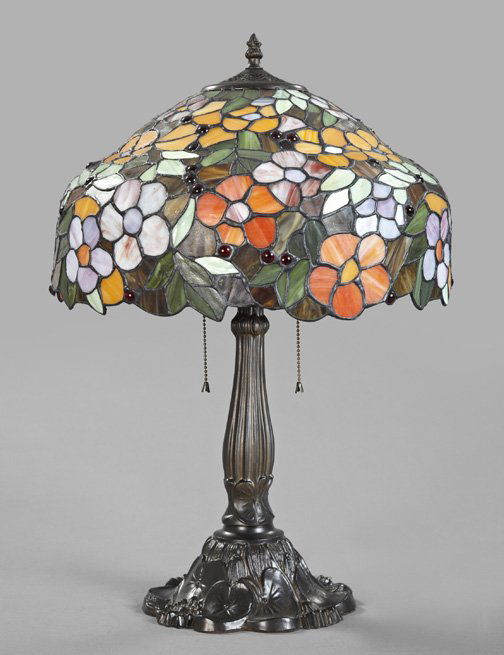 American Lamp Base and Stained Glass Shade: American Patinated Spelter "Lily" Lamp Base and Stained Glass Shade, in the manner of Louis Comfort Tiffany (American, 1848-1933), the five-petaled flowerheads in lavender and rose slag glass, burnt o