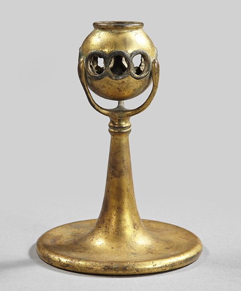Tiffany Gilt-Bronze Candlestick,: Tiffany Gilt-Bronze Candlestick, with a reticulated spherical candlesocket, the Favrile glass insets missing from all the reticulations, the base touchmarked "Tiffany Studios/New York/1210", h. 7-3/4"