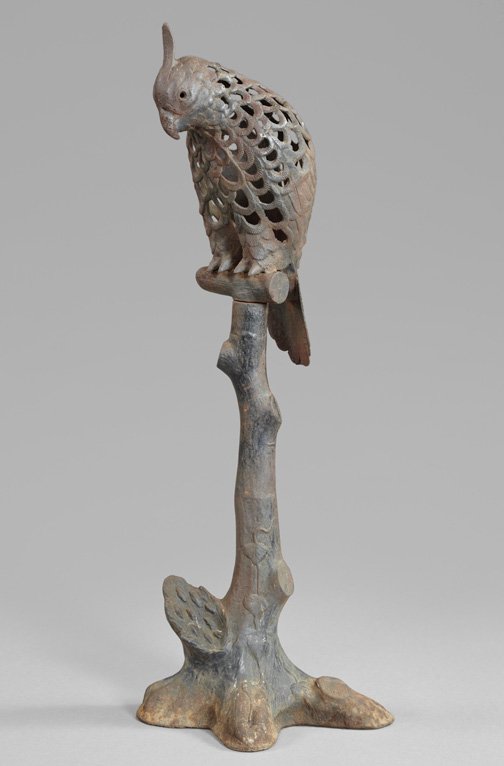 Unusual French Cast-Iron Garden Lantern,: Unusual French Cast-Iron Garden Lantern, first quarter 20th century, in the form of a parrot on a crabstock perch, the bird elaborately reticulated, presented in a naturally rusted old black-painted f