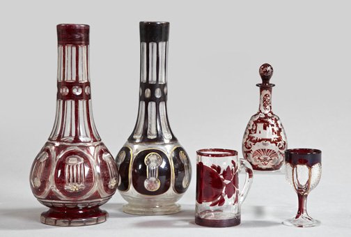Group of Bohemian Ruby-Stained Glass Items: Five-Piece Group of Bohemian Ruby-Stained Glass Items, consisting of a tall ruby-cased and parcel-gilt cut overlay glass garniture vase of bottle form, third quarter 19th century; a similar, slightly 