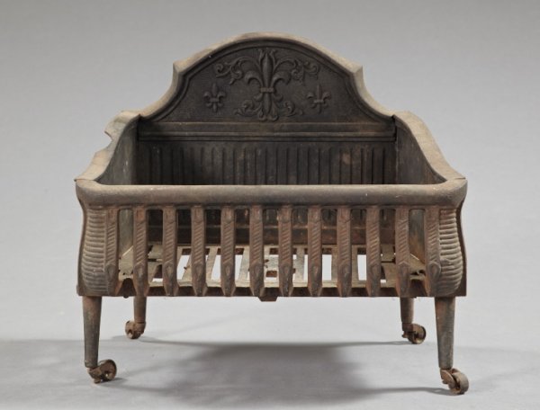 Unusual Cast-Iron Fireplace Log or Coal Crib,: Unusual Cast-Iron Fireplace Log or Coal Crib, third quarter 19th century, the backplate with a fleur-de-lis and raised on cylindrical legs, h. 17-3/4", w. 20-1/4", d. 13". Provenance: A Plantation nea