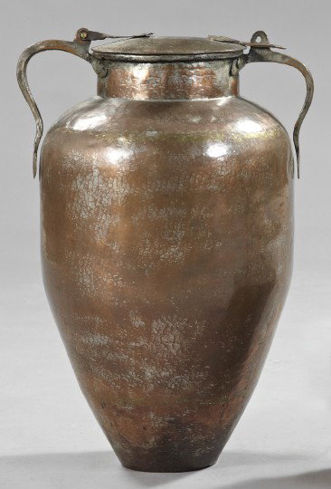 Middle Eastern Attenuated Pyriform Storage Jar: Large Middle Eastern Attenuated Pyriform Storage Jar, first quarter 20th century, composed of hand-beaten copper with wrought-iron handles, the copper with traces of a silver-wash finish, h. 27", dia.