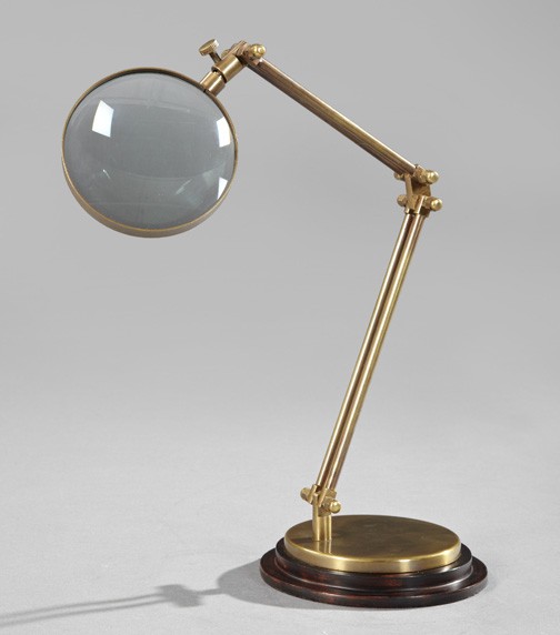 Edwardian-Style Brass Collector's Desk Magnifier: Edwardian-Style Brass Collector's Desk Magnifier, the adjustable arm above a circular rosewood-stained wooden base, extended h. 22".