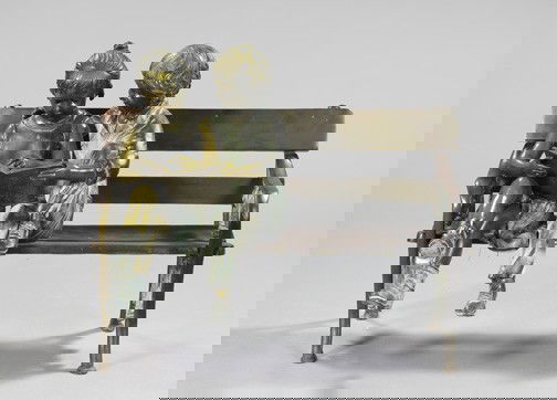 Manner of Jane DeDecker (American, Contemp): Manner of Jane DeDecker (American, Contemporary), a patinated bronze garden sculpture of a boy and girl reading on a bench, signed at the back of bench "A. MOREAU", h. 39", w. 46-1/4", d. 21-1/2".