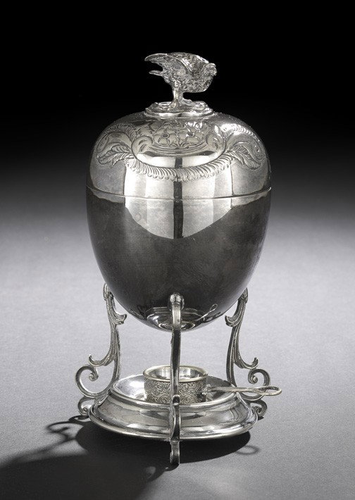 George V Silverplate Egg Cooker,: George V Silverplate Egg Cooker, first quarter 20th century, by Walker & Hall, Sheffield, of ovoid form, the lid decorated with repousse foliate rococo scrolls, surmounted by a figural finial of a nes