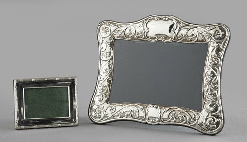 Group of Two English Photograph Frames,: Group of Two English Photograph Frames, consisting of a sterling silver-faced example in the Edwardian style, with a blue velvet back and easel, h. 8-3/4", w. 10-3/8"; and a smaller sterling silver-fa