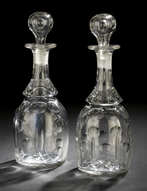 Pair of Edwardian Blown Glass Decanters: Good Near Pair of Edwardian Blown Glass Decanters, first quarter 20th century, petal and oculus cut, each retaining the period spherical cut glass stopper, h. 12".