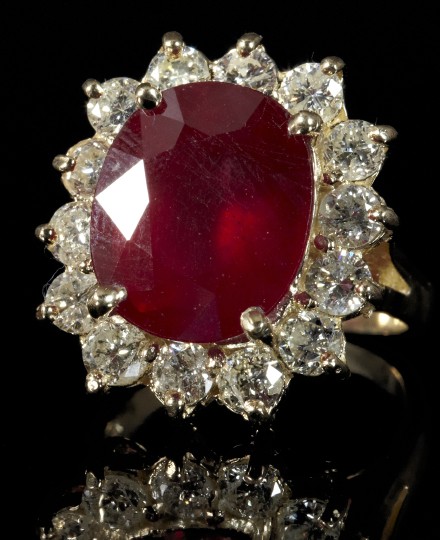Gold, Ruby and Diamond Lady's Ring: Fine Fourteen-Karat Yellow Gold, Ruby and Diamond Lady's Ring, composed of a central oval faceted-cut ruby, surrounded by a round brilliant-cut two-tiered white diamond bezel, supported by a yellow go