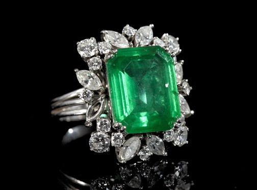 Gold, Diamond and Synthetic Emerald Ring: Lady's Fourteen-Karat White Gold, Diamond and Synthetic Emerald Triplet Dinner Ring, composed of a central rectangular step-cut synthetic green triplet surrounded by marquise- and round-cut white diam