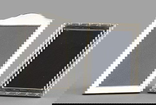 Group of Two Photograph Frames,: Group of Two Photograph Frames, consisting of an Italian sterling silver arched frame with a lacquered rosewood-grained backplate and easel; and an English ribbon-bound reeded sterling silver frame, 1