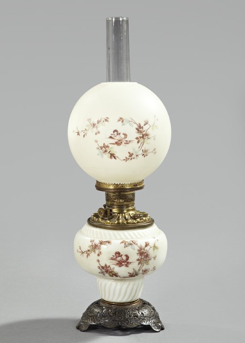 American Glass Kerosene Parlor Lamp: American Cast-Iron- and Brass-Mounted White Opal Glass Kerosene Parlor Lamp, fourth quarter 19th century, now electrified, the base and period globular white opal glass shade in floral "putto" decor, 