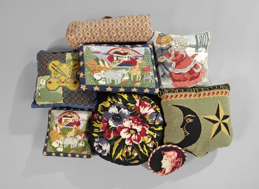 Collection of Seven Needlepoint Sofa Pillows: Interesting Collection of Seven Needlepoint Sofa Pillows, comprised of a shield-form example featuring the man-in-the-moon and a star, a square example of a pair of skating cats in Victorian dress, a
