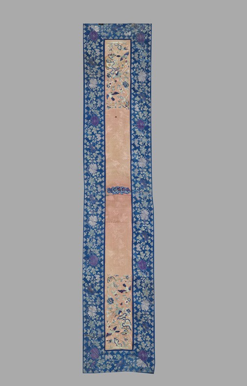 Chinese Silk Table Runner,: Chinese Silk Table Runner, composed of two peach silk sleeve bands embroidered with peacocks in "Tree Accompanied by Bird in Flight" decor, with a blue silk chrysanthemum floral border, w. 12", l. 60"