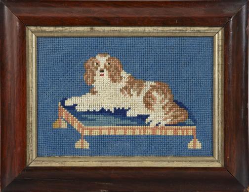 British Needlepoint Panel of a Cocker Spaniel: British Needlepoint Panel of a Cocker Spaniel, second quarter 19th century, the canine modeled reclining on his dog bed, verso affixed with a label, printed "Worked in 1838 by William Kitchen, aged 8