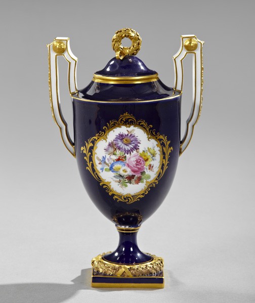 Meissen Porcelain Two-Handled Garniture Vase: Meissen Porcelain Covered Two-Handled Garniture Vase, fourth quarter 19th century, having a cobalt glue ground, each facade with a well-painted floral reserve framed in gilt scrolls in the Louis XVI t