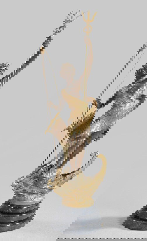 French Spelter Figure of a Windswept Triton,: French Spelter Figure of a Windswept Triton, fourth quarter 19th century, the bronze-patinated and parcel-gilt figure standing at the prow of a boat and holding his trident and a sail, presented on a