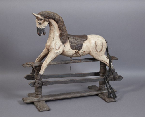 Large American Provincial Hobby Horse on Glider: Large American Provincial Hobby Horse on Glider, composed of carved and painted wood, horsehair, leather and tube iron, the steed with a leather saddle, long horsehair tail and mounted to a back-and-f