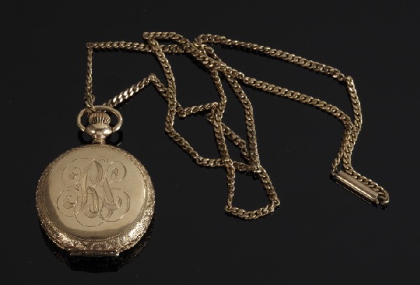 Gold Lady's Waltham Hunt Case Watch: Fourteen-Karat Yellow Gold Lady's Waltham Hunt Case Watch, the engraved yellow gold case enclosing a white enamel face with black numerals and a second dial, suspended on a curl link chain, chain l. 2