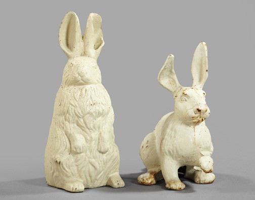 Two Anglo-American Cast-Iron Garden Figures: Two Anglo-American Cast-Iron Garden Figures of Rabbits, one sitting up on its backside and the other crouched with its proper left forepaw raised, both figures painted in a matte antique white with li
