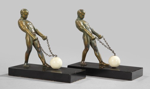 Unusual Pair of Art Deco Figural Bookends,: Unusual Pair of Art Deco Figural Bookends, second quarter 20th century, composed of weighted and patinated spelter, each featuring a well-muscled male athlete drawing back a chained white marble spher