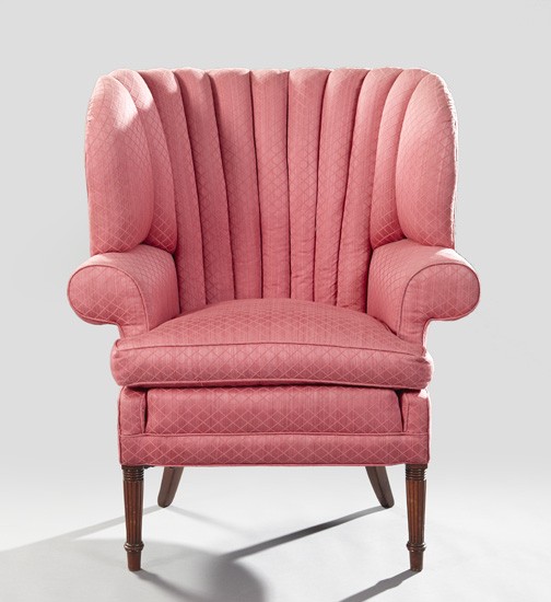 Edwardian Mahogany Wing-Back Chair,: Edwardian Mahogany Wing-Back Chair, second quarter 20th century, the tufted curved back joined to the cushioned seat by outscrolled arms, raised on reeded and tapering legs ending in toupie feet, h. 4