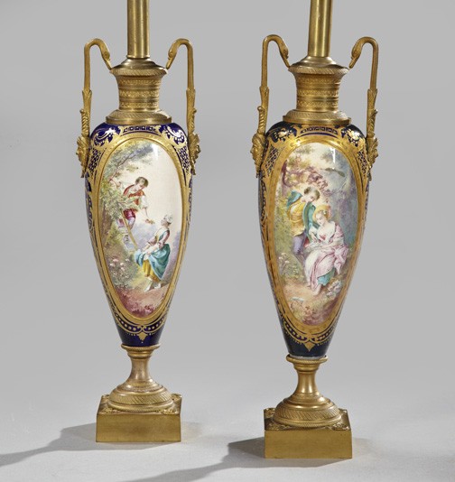 French Gilt-Brass-Mounted Porcelain Lamps: Pair of French Gilt-Brass-Mounted Porcelain Garniture Vases, fourth quarter 19th century, of attenuated baluster form in the Louis XVI style, the gilt-brass handles with diademed female-masque basal t
