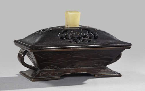 Japanese White Jade Covered Incense Burner,: Japanese White Jade Covered Incense Burner, first quarter 20th century, of oblong form, the ebony cover pierced and centered with a rectilinear jade grip, the interior fitted with a copper mesh ash sc