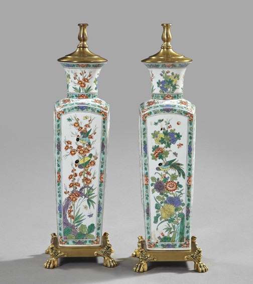 Chinese Famille Verte Porcelain Garniture Vases: Pair of Chinese Famille Verte Porcelain Garniture Vases, of tall square section in the Ch'ien Lung style, now mounted in gilded brass as table lamps, the gilt-brass basal mounts with boldly modeled pa