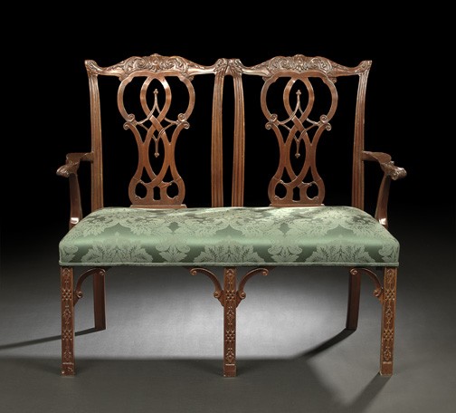 George III-Style Mahogany Settee,: George III-Style Mahogany Settee, the double chairback surmounted by shaped and earred foliate-carved crests above interlacing pierced splats, joined by outscrolled arms to the padded seat, raised on 
