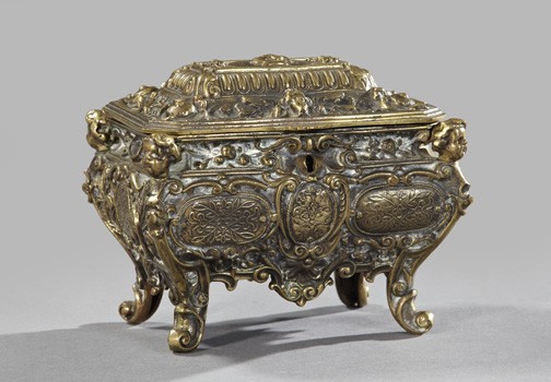 Continental Gilt-Brass Jewel Casket,: Continental Gilt-Brass Jewel Casket, first quarter 20th century, in the Baroque style, the upper corners ornamented with putto heads, the facade centered with a keyhole, the interior fully lined in sc