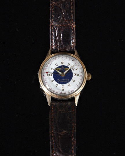 Gentleman's Movado Calendomatic Wristwatch,: Gentleman's Movado Calendomatic Wristwatch, with gold top and stainless back, the blue and white enamel face with month and day windows, fitted with a leather strap.
