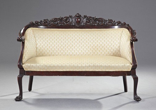 American Late Victorian Mahogany Settee,: American Late Victorian Mahogany Settee, fourth quarter 19th century, in the manner of Karpen, the curved back with a deep pierced and scroll-carved wraparound crest and terminating into scrolled knuc