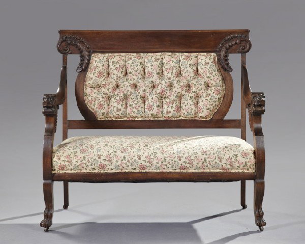American Late Victorian Mahogany Settee,: American Late Victorian Mahogany Settee, fourth quarter 19th century, the padded and tufted back back with scrolled feather-carved returns, the arm fronts depicting lion heads, raised on cabriole legs