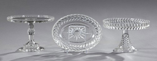 American Glass Cake Stands and a Serving Bowl: Two American Pressed Glass Cake Stands and a Serving Bowl, first quarter 20th century, comprised of a circular footed cake stand in "Dakota" pattern, ca. 1885-1898, h. 6-3/4", dia. 9-1/2"; a slightly 