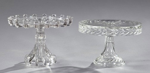 Two Good American Pressed Glass Cake Stands,: Two Good American Pressed Glass Cake Stands, first quarter 20th century, composed of a "Broken Column" footed cake stand, h. 8", dia. 10-1/2"; and a Brilliant-pressed "Laurel Wreath" circular footed c