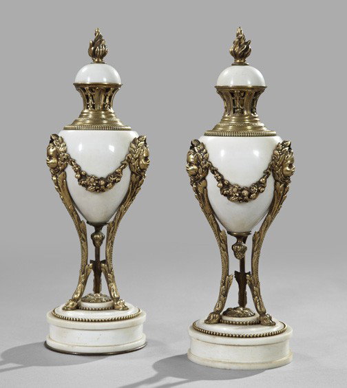 Belle Epoque Marble Garniture Vases: Pair of Belle Epoque Gilt-Brass-Mounted Carrara Marble Covered Garniture Vases, first quarter 20th century, in the Louis XVI style, the oviform bodies supported on a trio of putto-masque monopods conn