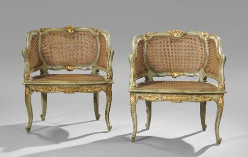 Louis XV-Style Polychromed Parcel-Gilt Bergere: Pair of Louis XV-Style Polychromed and Parcel-Gilt Bergeres, first quarter 20th century, each with a shaped crest centered by a cartouche carving, over a conforming caned back, joined to the cushioned