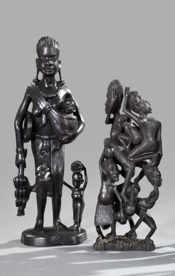 Two African Carved Ebony Figure Groups,: Two African Carved Ebony Figure Groups, one with six intricately intertwined figures stacked in two registers, and the other with a standing female figure with two small children, holding a stalk of b