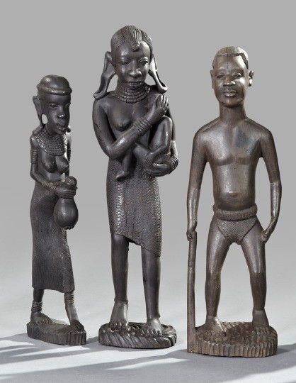 Three African Carved Ebony Figure Groups,: Three African Carved Ebony Figure Groups, 20th century, comprised of a male figure holding a walking stick, a female figure holding a calabash vessel and a female figure holding a small child, the lar