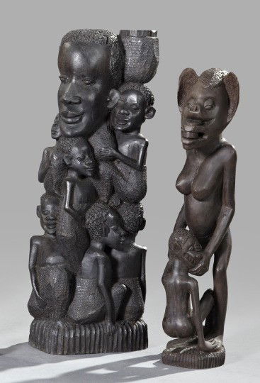 Two African Carved Ebony Figure Groups,: Two African Carved Ebony Figure Groups, 20th century, one depicting a standing female figure holding a crouching figure, h. 16", and the other depicting a group of eight small figures encircling a lar